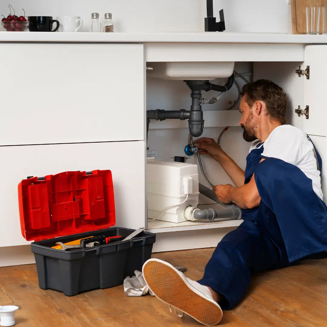 Professional plumber repairing kitchen sink in Oakville Ontario